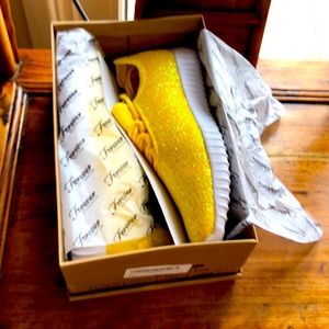 Yellow sparkled sneakers.